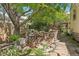 Private backyard with water feature, stone pathway and mature tree at 7513 Simms Ct, Arvada, CO 80005
