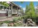 Lush backyard featuring deck, mature landscaping and tranquil stream at 7513 Simms Ct, Arvada, CO 80005