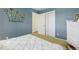 Comfortable bedroom features wood floors, dresser, closet and a large bright window at 7513 Simms Ct, Arvada, CO 80005