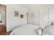 This bedroom features hardwood floors, an area rug, and bright walls at 7513 Simms Ct, Arvada, CO 80005