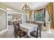 Bright dining area connecting to a living room, featuring a table with seating and natural light at 7513 Simms Ct, Arvada, CO 80005