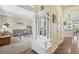 Charming entryway with coat rack, seating, and access to the living room and kitchen at 7513 Simms Ct, Arvada, CO 80005