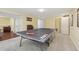Bright game room with ping pong table, neutral carpet, and easy access to other rooms at 7513 Simms Ct, Arvada, CO 80005