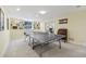 Spacious game room with a ping pong table, built-in bookshelves, and an adjacent office space at 7513 Simms Ct, Arvada, CO 80005