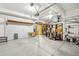 Spacious garage with ample storage shelving, a work table, and room for multiple vehicles or hobbies at 7513 Simms Ct, Arvada, CO 80005