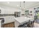 Bright kitchen features a large center island with marble countertops and stainless steel appliances at 7513 Simms Ct, Arvada, CO 80005