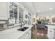 This gourmet kitchen is complete with marble countertops, dark hardware, and stainless steel appliances at 7513 Simms Ct, Arvada, CO 80005