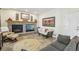 Inviting living room with a fireplace, neutral paint colors, and lots of natural light at 7513 Simms Ct, Arvada, CO 80005