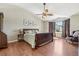 Inviting main bedroom features vaulted ceiling, ceiling fan, wood floors, and natural light at 7513 Simms Ct, Arvada, CO 80005