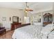 Bright main bedroom featuring wood floors, ceiling fan and access to the main bathroom at 7513 Simms Ct, Arvada, CO 80005