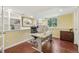 Bright office with built-in shelving, wood floors, and glass doors for natural light at 7513 Simms Ct, Arvada, CO 80005
