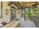 Relaxing covered porch with ceiling fan and comfortable seating area at 7513 Simms Ct, Arvada, CO 80005