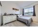 Cozy bedroom featuring a window, dresser, and decor at 14700 E 104Th Ave # 1404, Commerce City, CO 80022