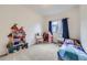 Bright bedroom with a dollhouse and decor at 14700 E 104Th Ave # 1404, Commerce City, CO 80022