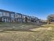 View of townhomes and community green space, showcasing the property's exterior and neighborhood at 14700 E 104Th Ave # 1404, Commerce City, CO 80022