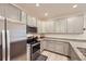 Well-equipped kitchen with stainless steel appliances, sleek gray cabinetry, and granite countertops for a modern look at 14700 E 104Th Ave # 1404, Commerce City, CO 80022