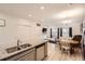 Open-concept kitchen with granite countertops and stainless steel appliances, flowing into the dining and living areas at 14700 E 104Th Ave # 1404, Commerce City, CO 80022