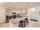 Modern kitchen with gray cabinets, granite countertops, and stainless steel appliances, plus an island with bar stool seating at 14700 E 104Th Ave # 1404, Commerce City, CO 80022