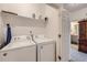 Bright laundry room featuring appliances and shelving at 14700 E 104Th Ave # 1404, Commerce City, CO 80022