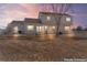 Well-maintained backyard with green grass, mature trees, and a view of the home's exterior at 15543 Quivas St, Broomfield, CO 80023