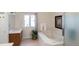 Serene bathroom with a soaking tub, a window that provides natural light, and modern fixtures at 15543 Quivas St, Broomfield, CO 80023