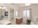 Bright bathroom featuring a soaking tub, modern fixtures, and a vanity with ample counter space at 15543 Quivas St, Broomfield, CO 80023