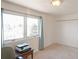 Bright bedroom featuring a large window with a view, plush carpet and a closet with bi-fold doors at 15543 Quivas St, Broomfield, CO 80023