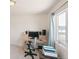 Neutral toned bedroom with a work area by the window featuring a desk and a printer on a small table at 15543 Quivas St, Broomfield, CO 80023
