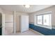 Bright bedroom with a closet, carpet flooring, blue-patterned accent wall, and a large window at 15543 Quivas St, Broomfield, CO 80023