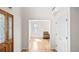 Bright foyer featuring hardwood floors, a wooden door, and an open doorway at 15543 Quivas St, Broomfield, CO 80023