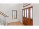 Bright foyer with hardwood floors, a wooden door with glass, and a staircase at 15543 Quivas St, Broomfield, CO 80023