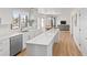 Bright kitchen featuring white cabinets, stainless steel appliances, and an island at 15543 Quivas St, Broomfield, CO 80023
