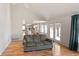 Bright living room featuring hardwood floors, a vaulted ceiling, and an open layout to the kitchen at 15543 Quivas St, Broomfield, CO 80023
