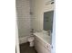 Bright bathroom featuring subway tile, updated vanity, and shower over tub at 1284 Osceola St, Denver, CO 80204