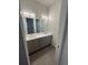 Modern bathroom with double vanity and sleek gray cabinets at 1284 Osceola St, Denver, CO 80204