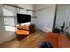 Cozy bedroom includes wooden dresser, shelving, and hardwood floor at 1284 Osceola St, Denver, CO 80204