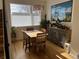Sunlit dining room features a wood table set, hardwood floors, and a large picturesque window at 1284 Osceola St, Denver, CO 80204