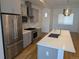Bright, modern kitchen with stainless steel appliances, white countertops, and sink island at 1284 Osceola St, Denver, CO 80204