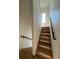 Hardwood staircase with black metal railing and natural light from window at 1284 Osceola St, Denver, CO 80204