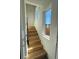 Staircase featuring light hardwood steps and adjacent windows for natural light at 1284 Osceola St, Denver, CO 80204