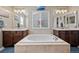 Lavish bathroom highlighting a centered soaking tub, double vanities, and a soothing color palette at 7967 E 139Th Pl, Thornton, CO 80602