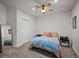 Bright bedroom with a ceiling fan, closet, and soft gray carpet at 7967 E 139Th Pl, Thornton, CO 80602