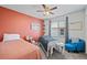 Bedroom with two beds, a blue accent chair, and modern decor at 7967 E 139Th Pl, Thornton, CO 80602