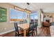 Inviting dining area filled with natural light, complemented by stylish modern light fixture at 7967 E 139Th Pl, Thornton, CO 80602