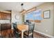 Bright dining room featuring hardwood floors, a contemporary light fixture and a large sunny window at 7967 E 139Th Pl, Thornton, CO 80602