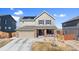 Charming two-story home features solar panels, a front porch, and a two car garage at 7967 E 139Th Pl, Thornton, CO 80602
