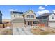 Charming two-story home features solar panels, a front porch, and a two car garage at 7967 E 139Th Pl, Thornton, CO 80602