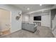Finished basement living room with sectional sofa and large-screen television at 7967 E 139Th Pl, Thornton, CO 80602