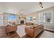 Inviting living room features a cozy fireplace, ceiling fan, and stylish hardwood floors at 7967 E 139Th Pl, Thornton, CO 80602