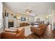 Inviting living room features a cozy fireplace, ceiling fan, and stylish hardwood floors at 7967 E 139Th Pl, Thornton, CO 80602